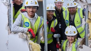 Read more about the article Students ‘break the wall’ to mark start of Willmott Dixon college build 